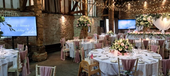 Screens at a wedding for video presentation